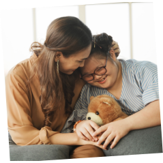 woman hugging a girl with down syndrome