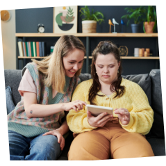 woman and a girl with disability using a tablet
