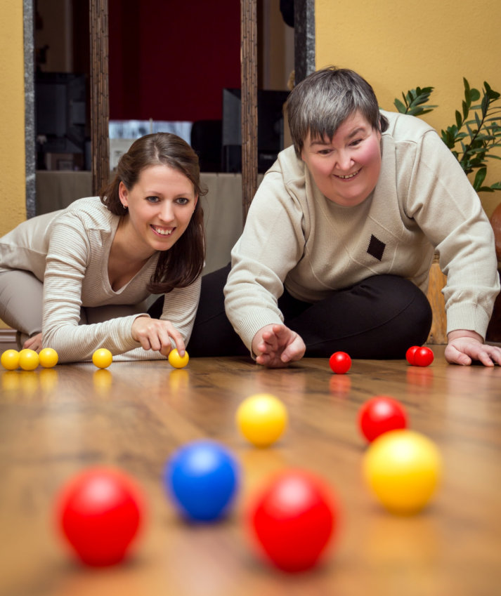 a woman and a person with disability playing together