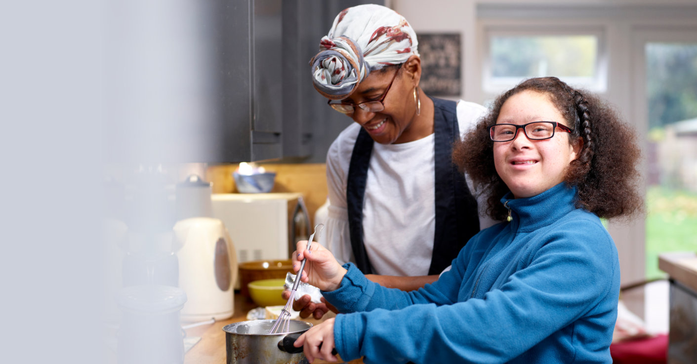 mother and her daughter with down syndrome cooking together