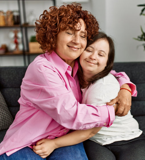 woman embracing her daughter with down syndrome