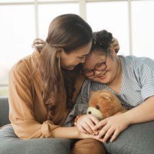 woman hugging a girl with down syndrome