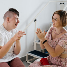 therapist doing development activities with disabled teenage child